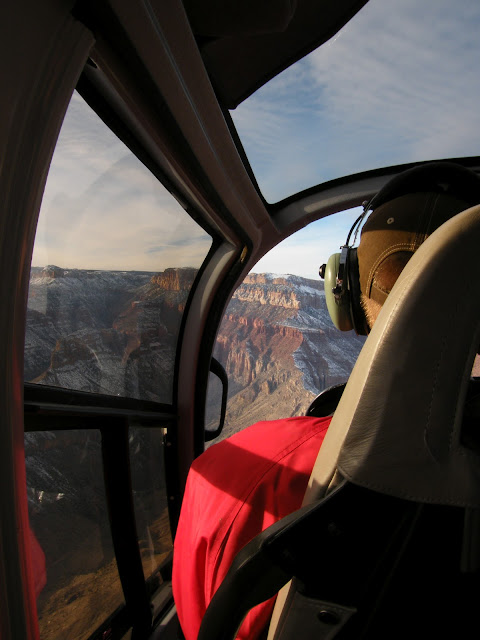 Helicopter pilot in action over Grand Canyon