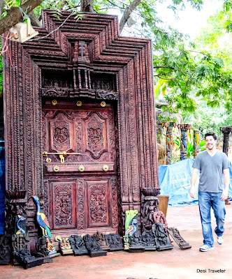A Tourist at shilparamam carved wooden door at shilparamam for sale