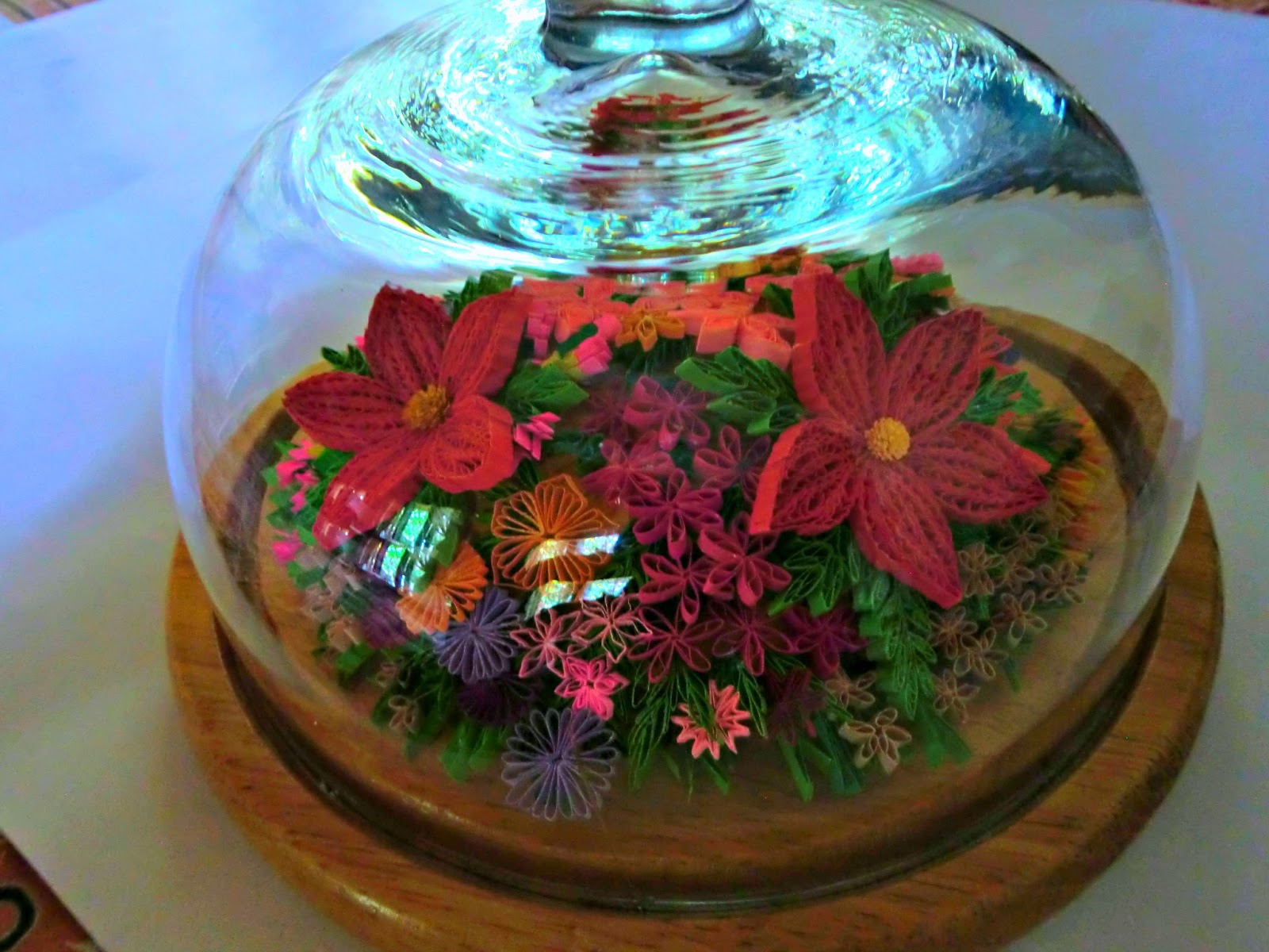 thought would take a break from wall hangings do a table decoration the flowers could be protected from dust and fading because of the glass cover