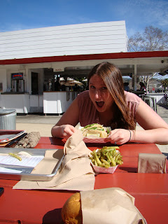 a woman eating a sandwich at a restaurant