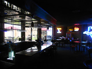 a bar with tables and chairs