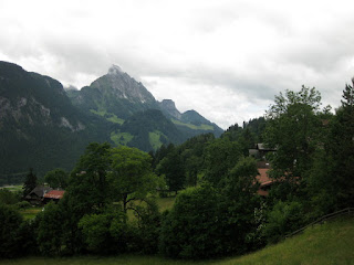 Green hills and distant cloudy peaks near St. Stephan, Switzerland