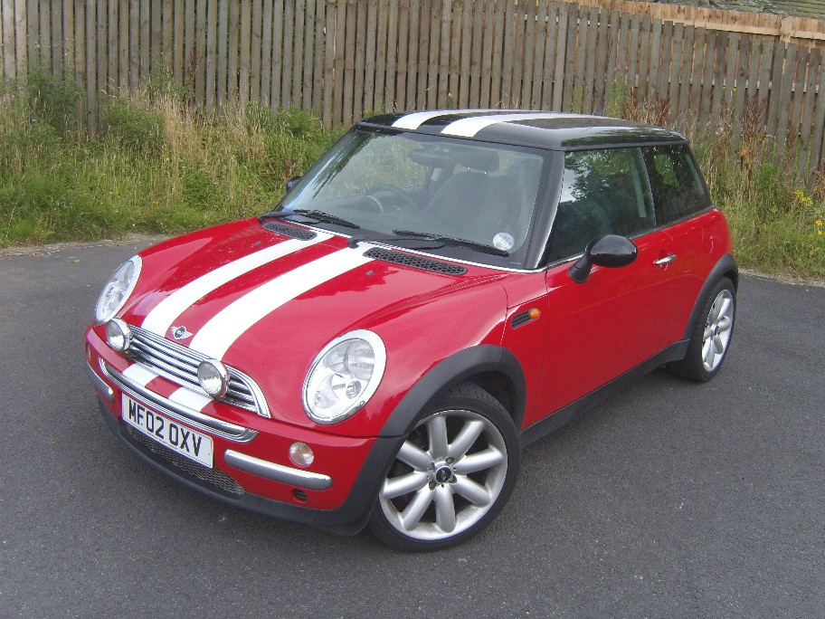 So much fun this Mini Cooper in cherry red with white racing stripes is the 