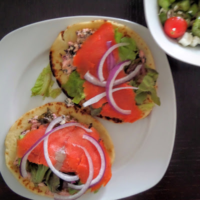 Smoked Salmon Mini Flatbread Sandwiches:  Smoked salmon atop a warm feta spread with lettuce and red onions on miniature naan bread.