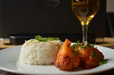 Hainanese chicken rice. Served with gobi manchurian and a glass of apple juice.