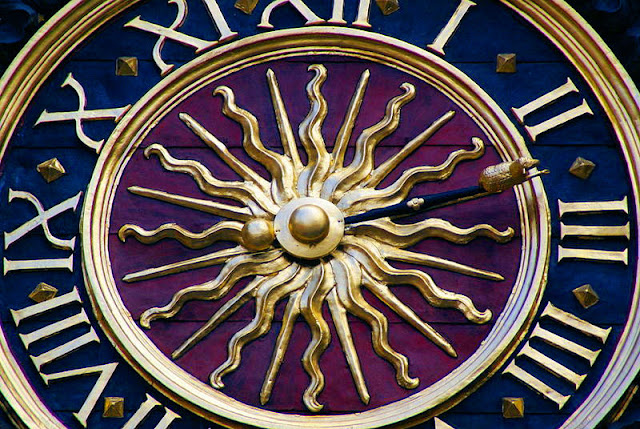 Close-up view of the Gros Horloge or Big Clock. Note the vibrant colors and  the lamb at the end of the hour hand. Photo: WikiMedia.org.