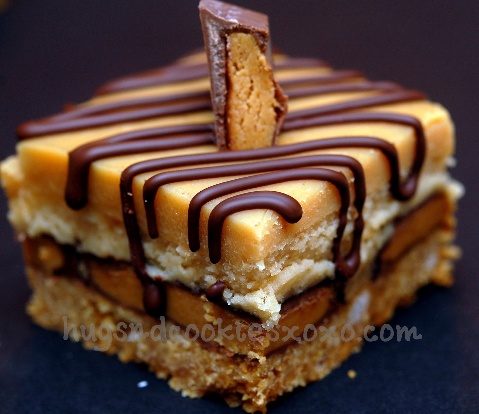 PEANUT BUTTER CHEESECAKE OVER PEANUT BUTTER CUPS SITTING ON A GRAHAM