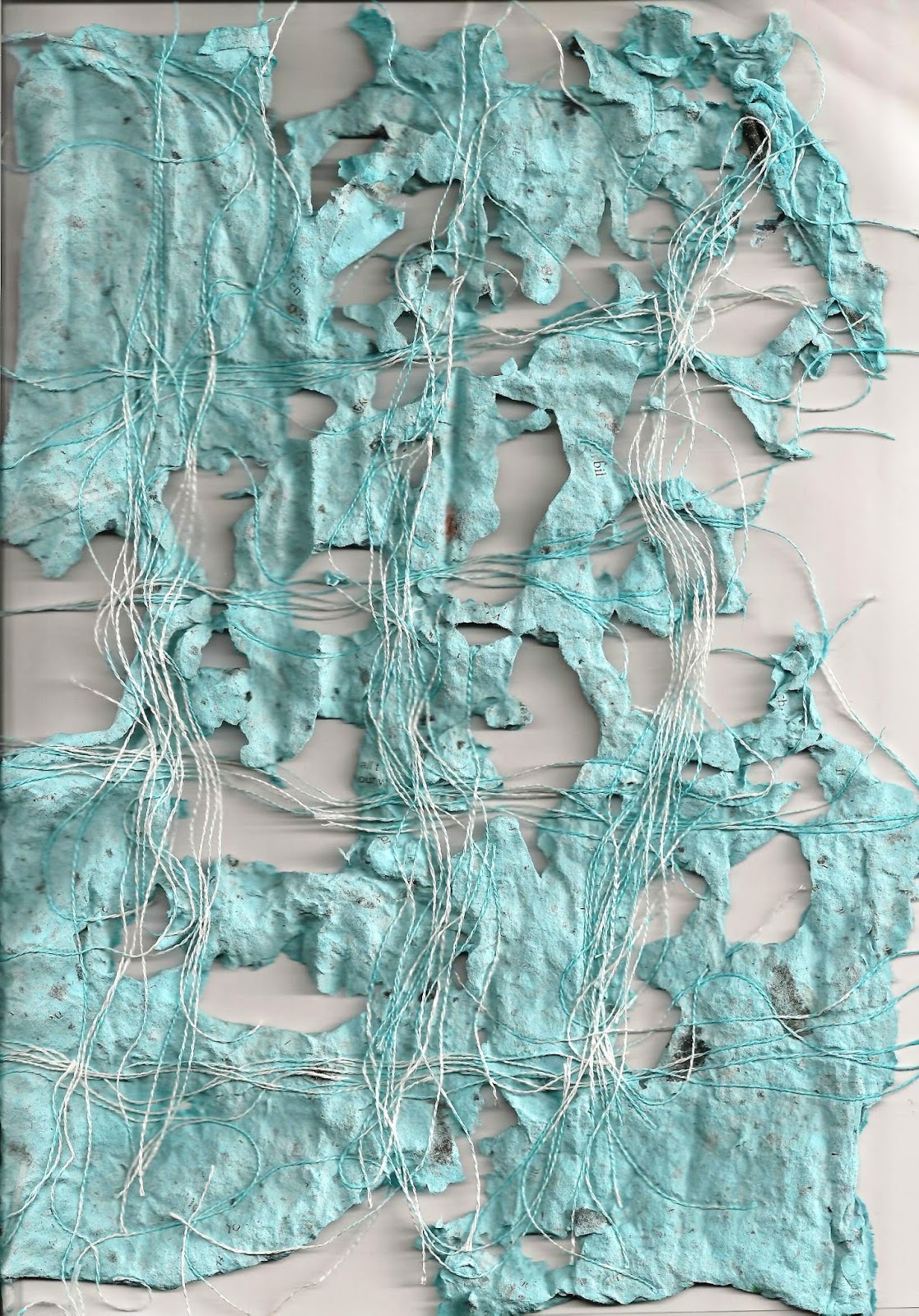 Stitch mark Applying paper pulp to woven fabric grid