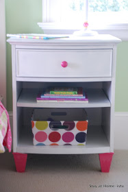 white nightstand with pink feet