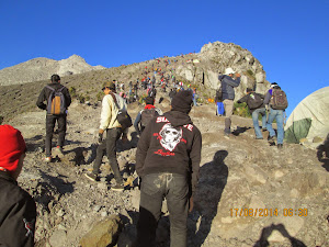 A crowd of trekkers climbing to the plateau summit of Mt Merapi.