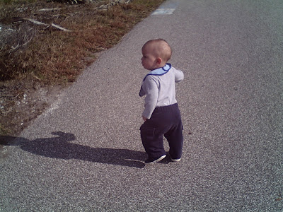 Baby walking towards the trees