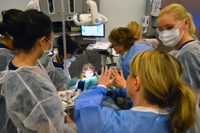 image of dental hygiene students working with a young child.