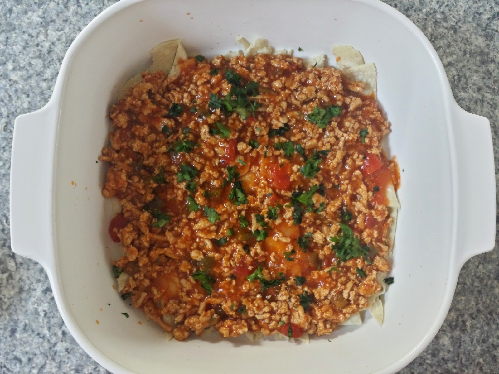 white corn tortillas with the meat sauce on top