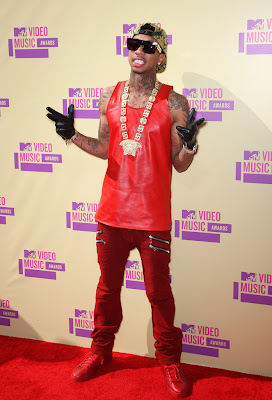 Tyga-supreme-snakeskin-hat-Celine-gold-chain-sunglasses-red-leather-tank-top-Balmain-jeans-red-sneakers-Upscalehype.jpg