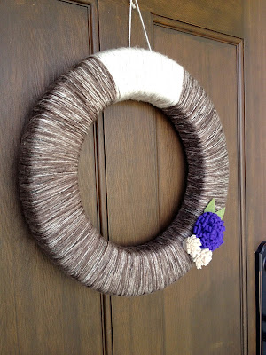 Yarn wreath with felt flowers