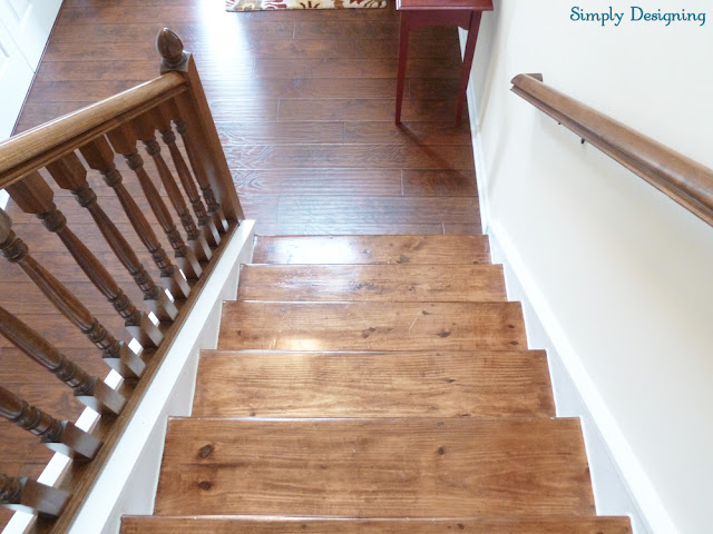 Photo of wood stairs that need to be restained because they don't match installed laminate floors