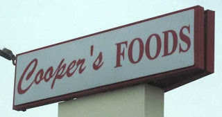Cooper's Foods sign with handwriting script Cooper and straight apostrophe
