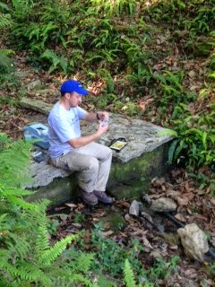 A team member from Water Missions International tests a water source in the Gorkha district 