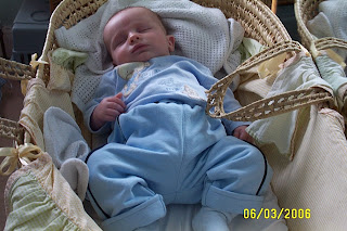 moses basket with pillows and sleeping child