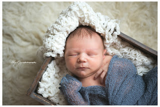 Baby photo with newborn in box wrapped with blankets