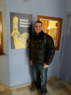 a man standing next to a sign