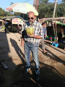 Drinking a giant size coconut in Namphalong in Myanmar.