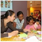 Parents help their children to finish the craft project