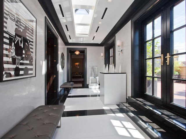 Nbaynadamas Park Avenue Penthouse Apartment real estate listing black and white foyer with a skylight, black and white marble floor, black French doors leading to a patio, and leather benches