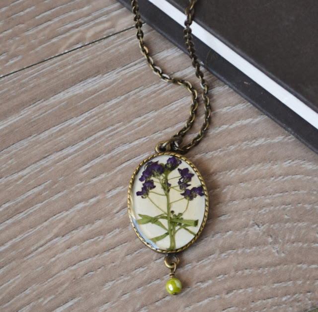 http://www.storenvy.com/products/3923131-purple-flower-necklce-oval-brass-pendant-with-flowers-resin-flower-jewelry