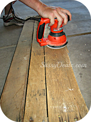 sanding the wood pallet for the wine rack