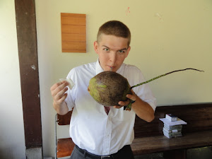 Ben drinking from a coconut