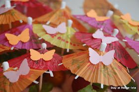Cocktail umbrellas with paper butterflies on top