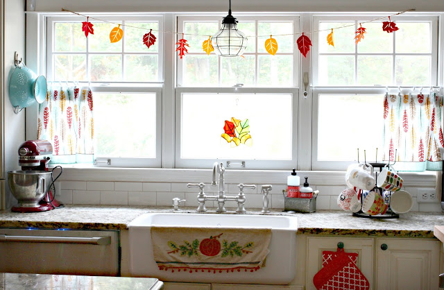 Fall leaf garland and HomeGoods dish towels as curtains in farmhouse style kitchen with farm sink-www.goldenboysandme.com
