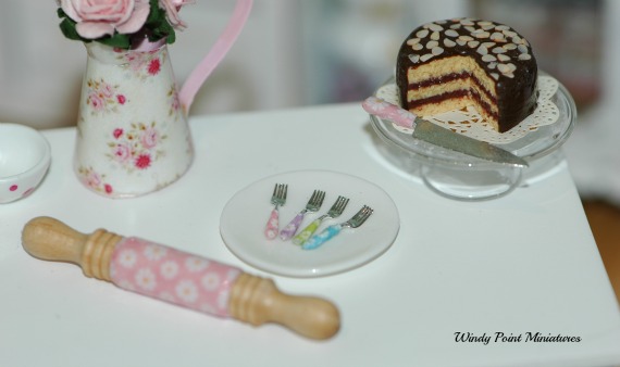 CDHM Gallery of Jennifer Reed of Windy Point Miniatures creating 1:12 dollhouse miniature food accessories, like customized flat ware, utensils, rolling pins, and mini food
