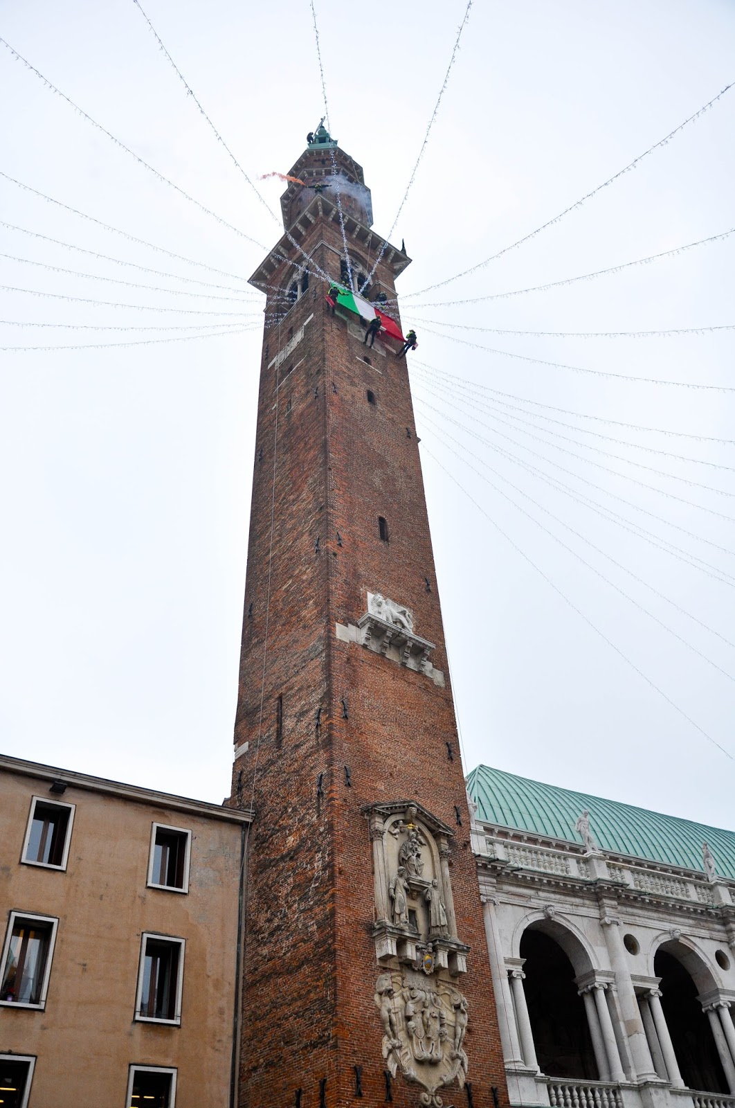 Firefighters climbing down the clock tower of the Palladio's Basilica, Saint Barbara celebration, Vicenza, Veneto, Italy