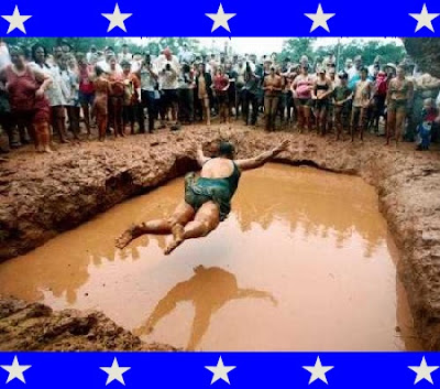 woman bellyflopping into a mud pit