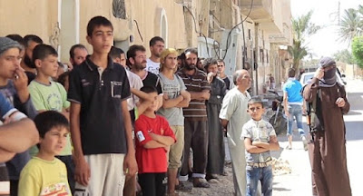 Children helped pelt two men with stones, as the Islamic State executed them for homosexuality. Homs, Syria, August 2015