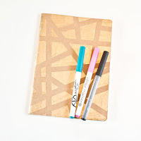 Adding gold leafing pen abstract designs to notebook covers Adding gold leafing pen abstract designs to notebook covers
