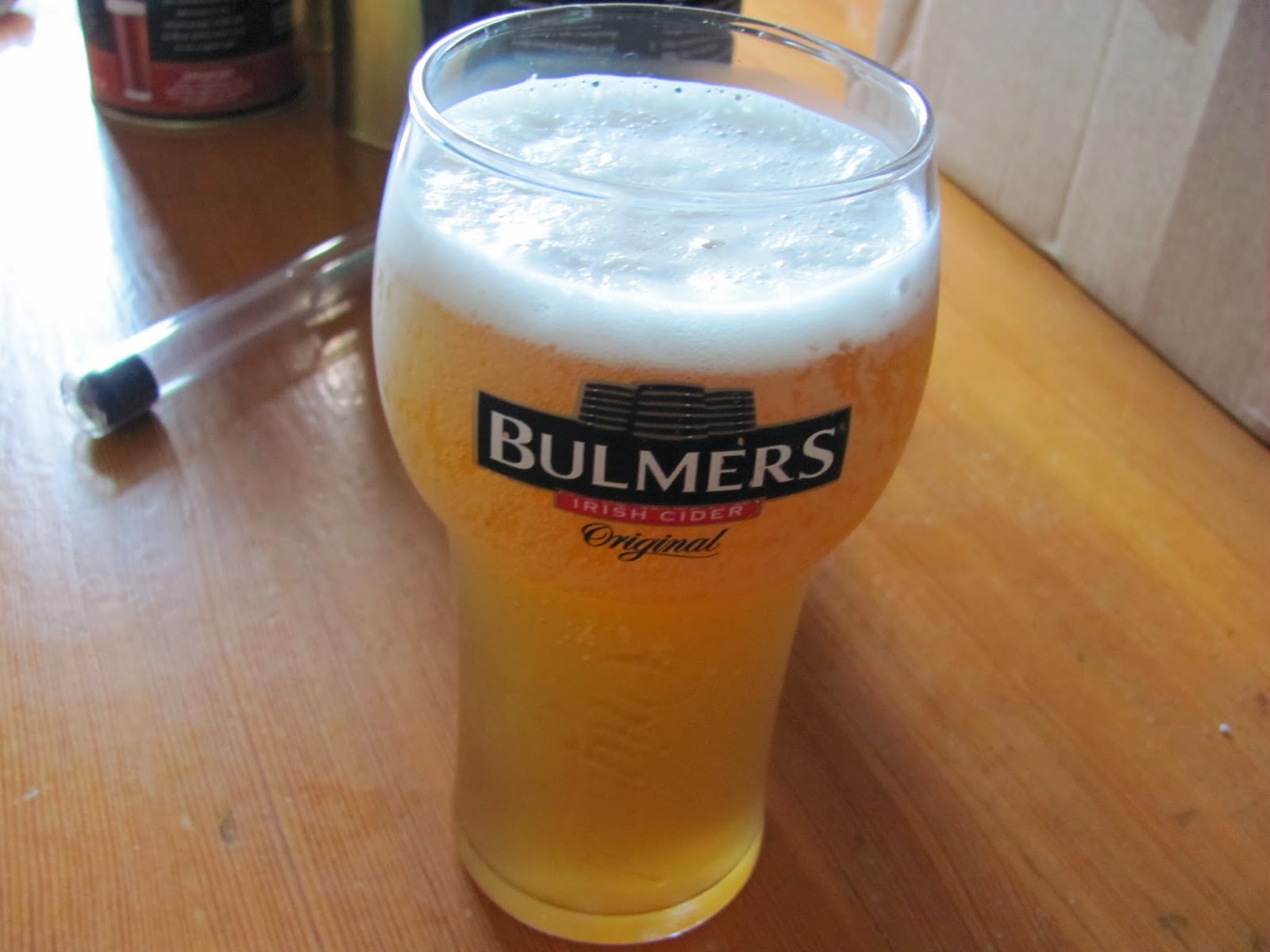 Brewing Homebrew and Drinking Homebrew A glass of homemade cider enjoyed while brewing