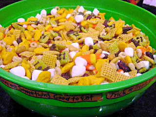 snack mix in a large green bowl
