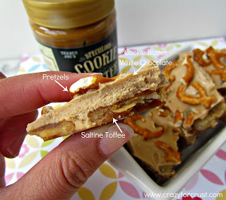 Biscoff pretzel toffee bark held in a woman's fingers with labels on each layer.