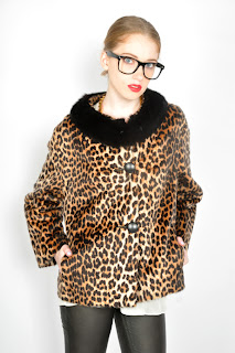 Vintage 1960's faux fur leopard coat with black mink trim and black leather covered buttons.