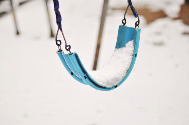 snow covered swing
