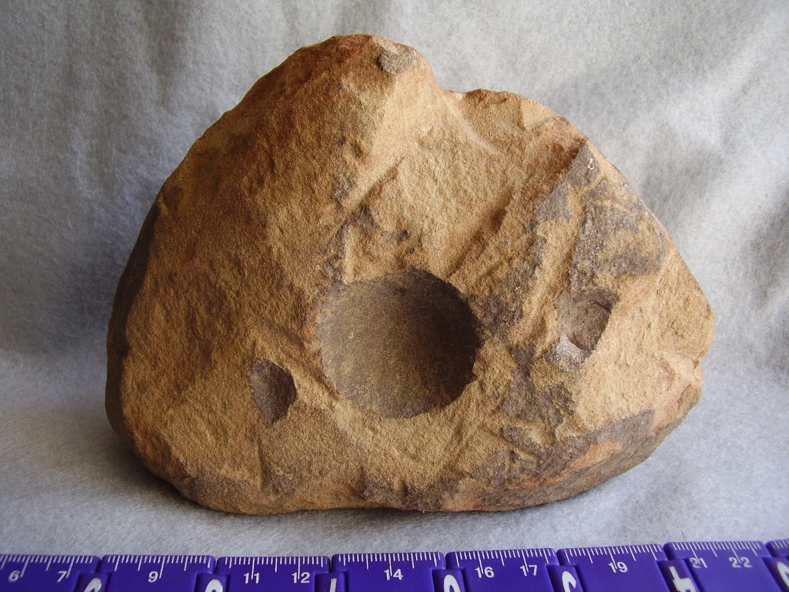Archaeology of Portable Rock Art Rocks' pits may be art "cupules" on