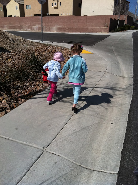 Trinity holding hands with a neighbor friend to the park. So cute!