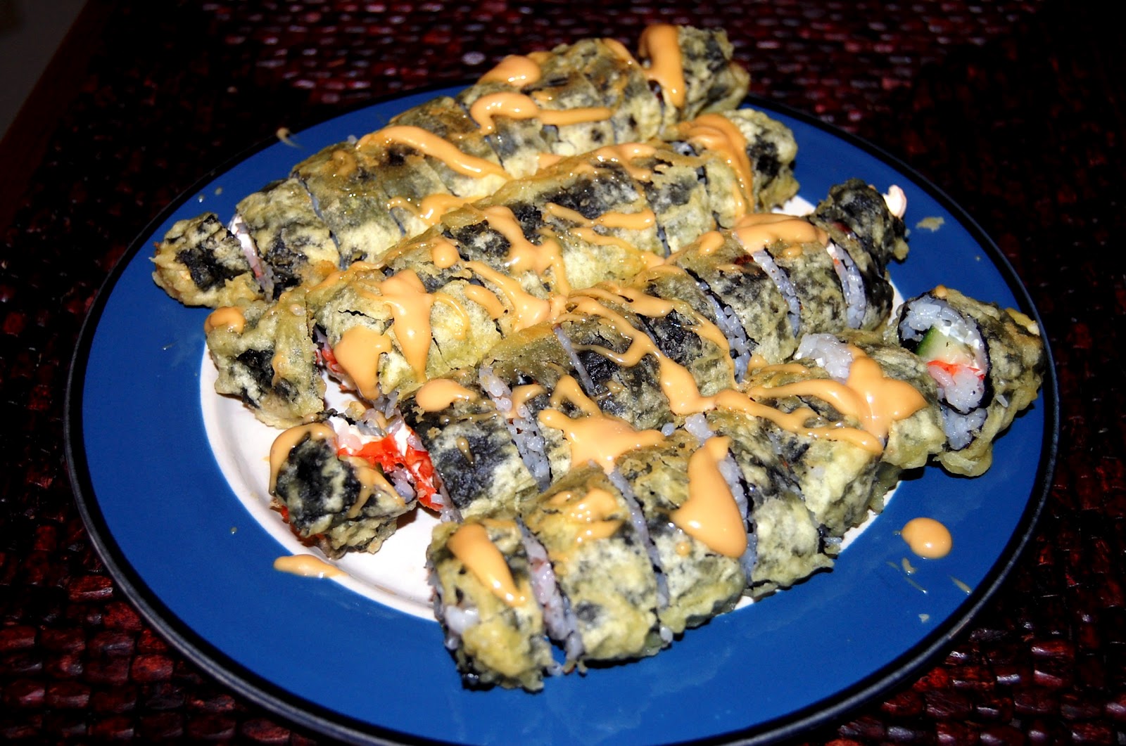 One Bite at a Time Deep Fried Sushi Drizzled with Spicy Sauce