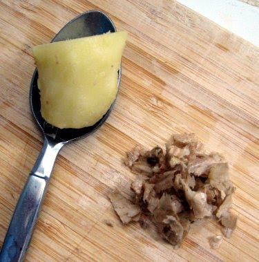 peeling fresh ginger with a spoon