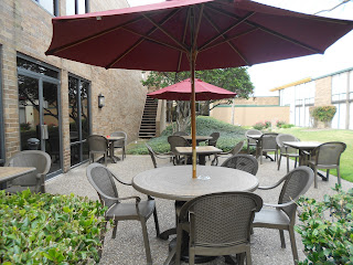 a table and chairs under an umbrella