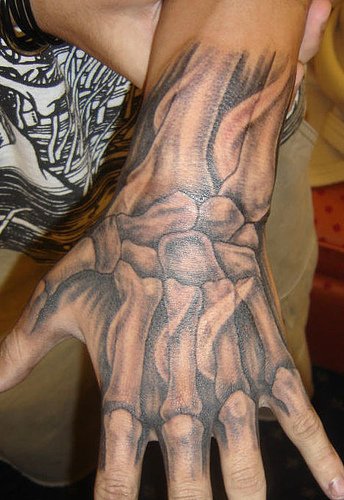 Elegant Arm and Chest Tattoos phoenix from a hand tattoo