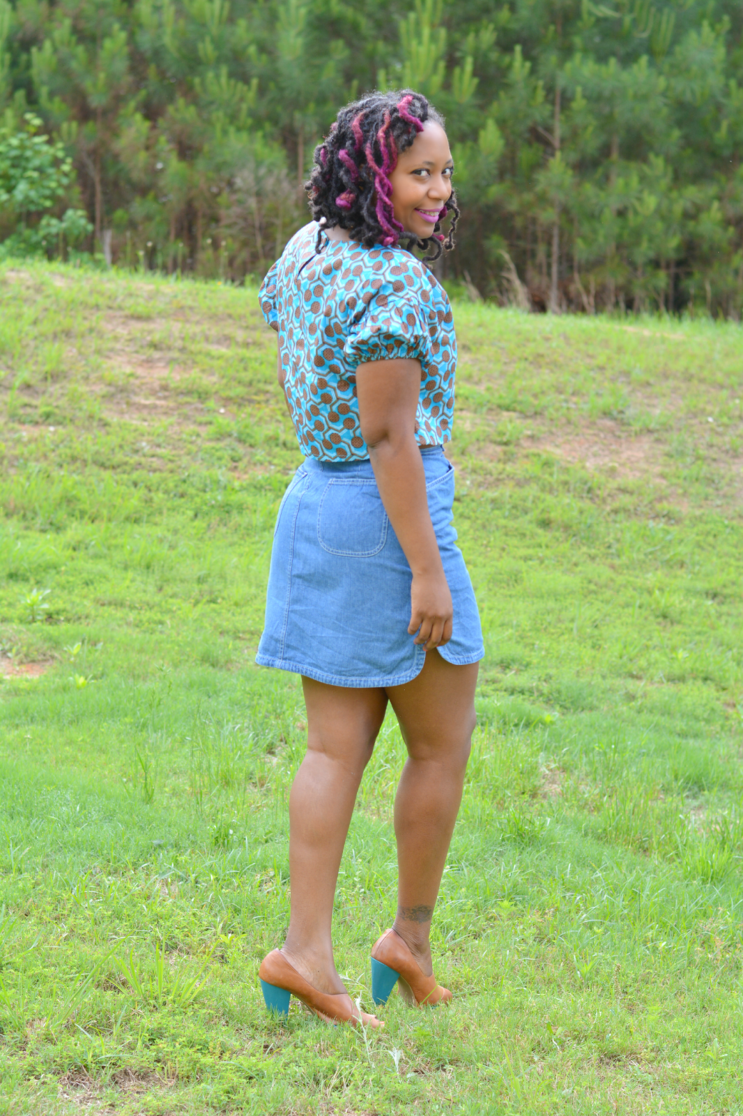 african print crop top worn with a high waist denim skirt